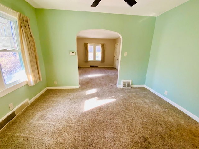 empty room with carpet and ceiling fan