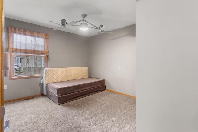 living area with ceiling fan and light carpet