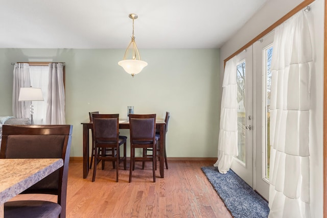 dining space with light wood-type flooring