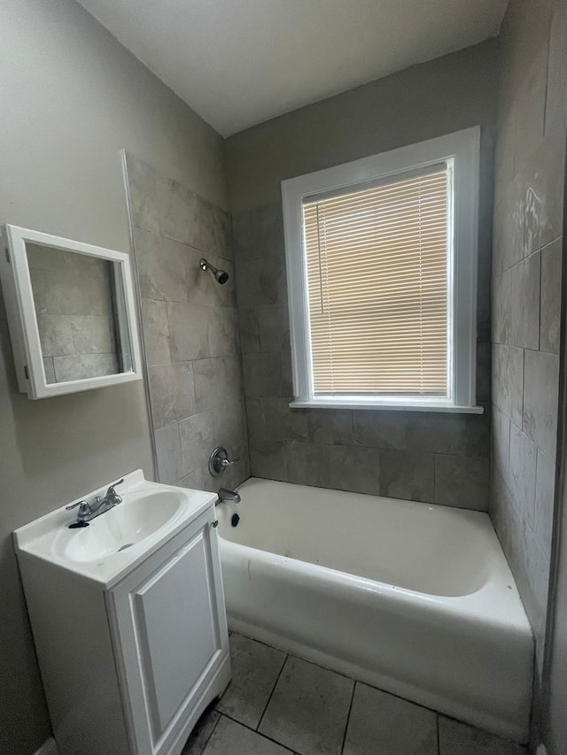 bathroom featuring vanity, tiled shower / bath combo, and tile patterned floors