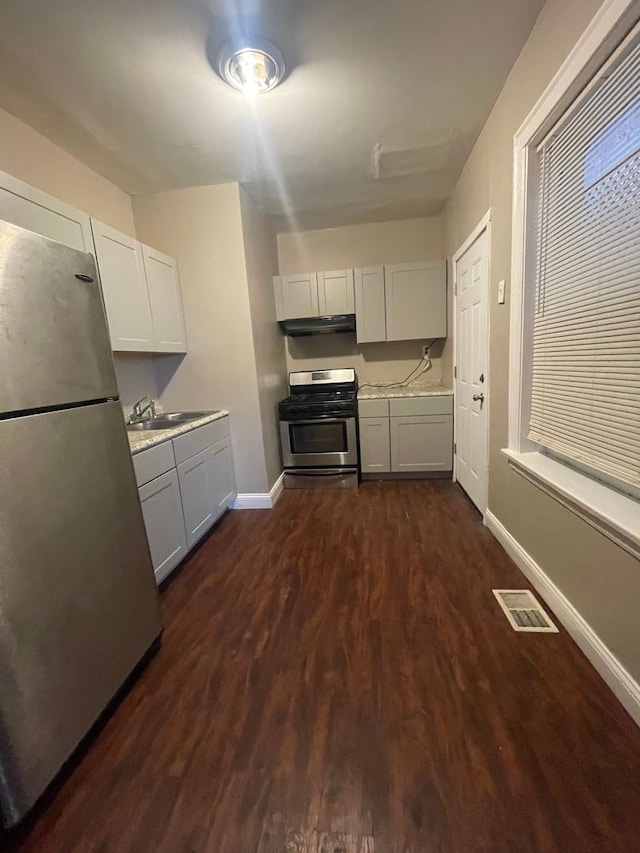 kitchen featuring white cabinets, dark hardwood / wood-style flooring, stainless steel appliances, and sink