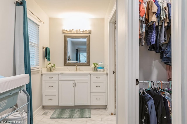 bathroom with a healthy amount of sunlight and vanity