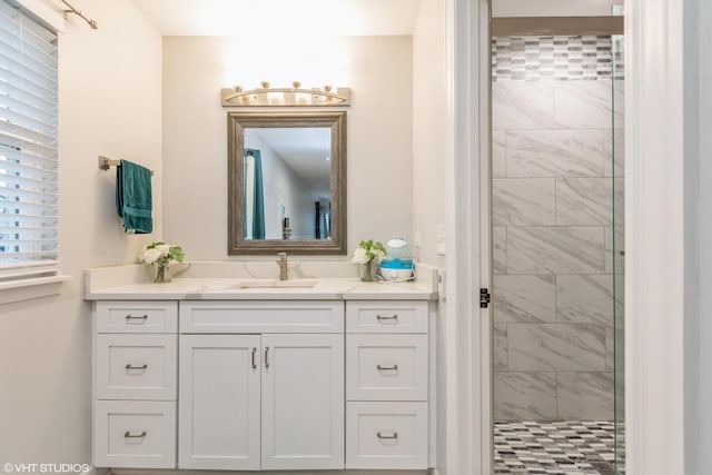 bathroom featuring vanity and tiled shower