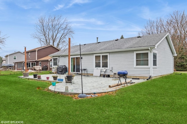 back of house with a yard and a patio