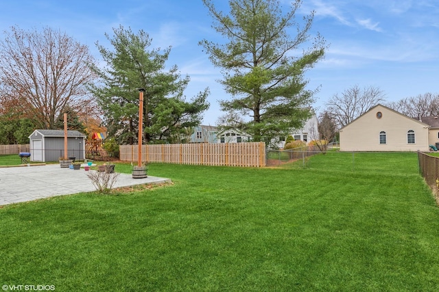 view of yard with a storage unit, a fire pit, and a patio