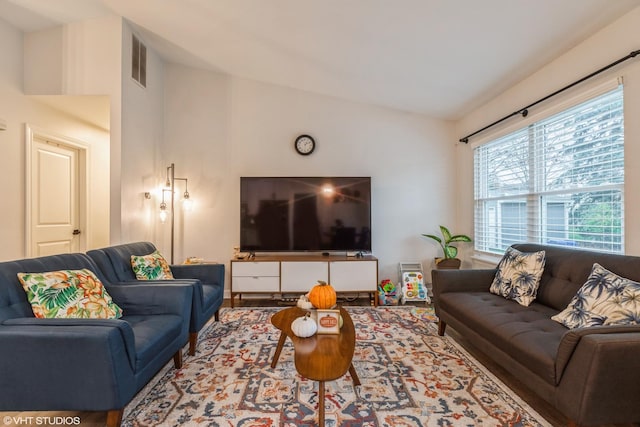 living room featuring vaulted ceiling