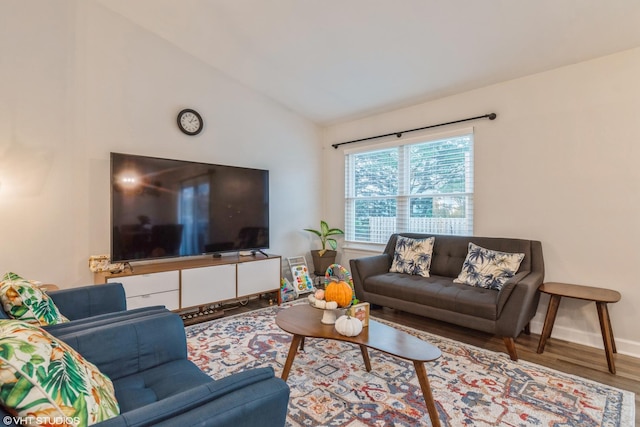 living room featuring vaulted ceiling and hardwood / wood-style floors