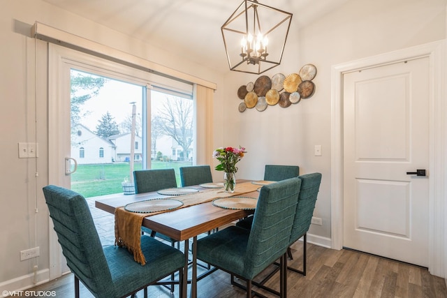 dining area featuring hardwood / wood-style floors and a chandelier