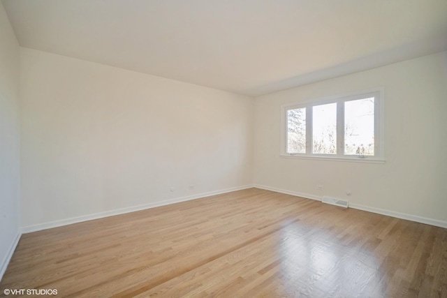 spare room with light hardwood / wood-style floors