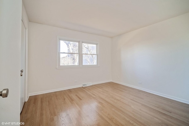 unfurnished room with light hardwood / wood-style floors