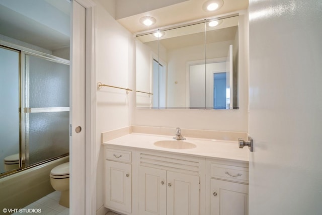 full bathroom with vanity, toilet, tile patterned flooring, and combined bath / shower with glass door