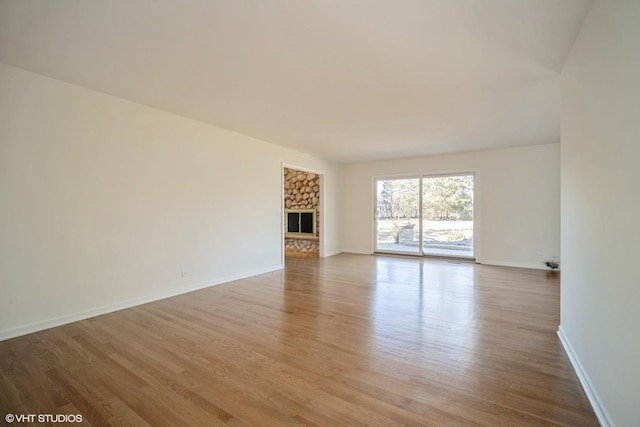 unfurnished living room featuring a fireplace and light hardwood / wood-style flooring