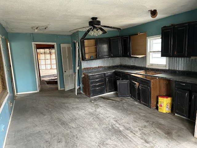 kitchen with ceiling fan and a textured ceiling