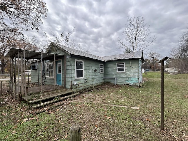 rear view of property with a lawn