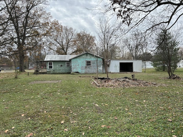 exterior space with a lawn and an outbuilding