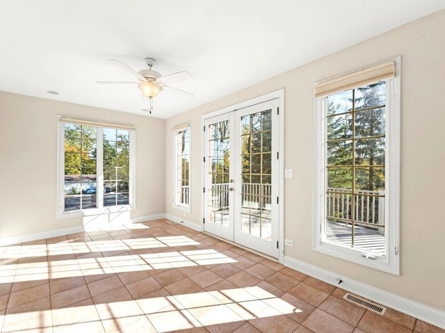 entryway featuring french doors, light tile patterned floors, and plenty of natural light