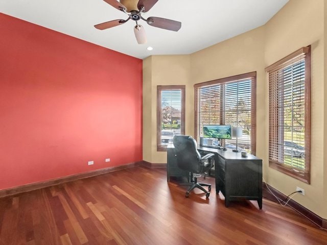 unfurnished office featuring hardwood / wood-style flooring and ceiling fan