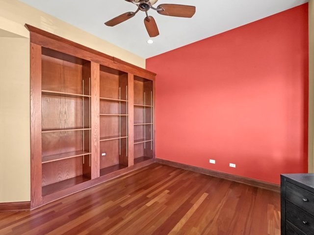 unfurnished bedroom featuring hardwood / wood-style flooring and ceiling fan