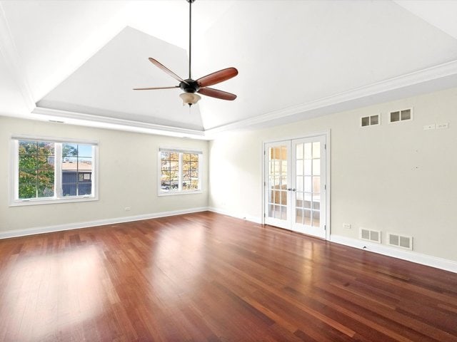 spare room with vaulted ceiling, ceiling fan, hardwood / wood-style floors, and french doors