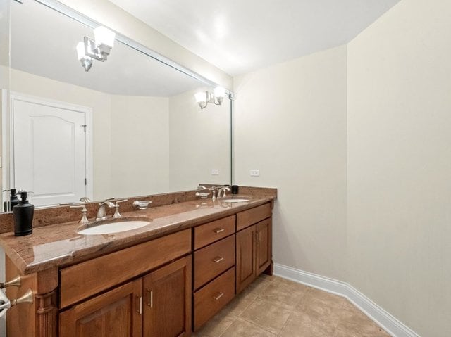 bathroom with tile patterned floors and vanity