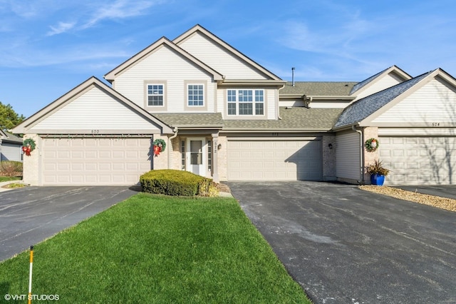 view of front of home with a garage and a front lawn