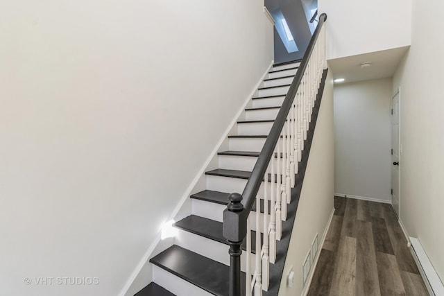 stairway with hardwood / wood-style flooring