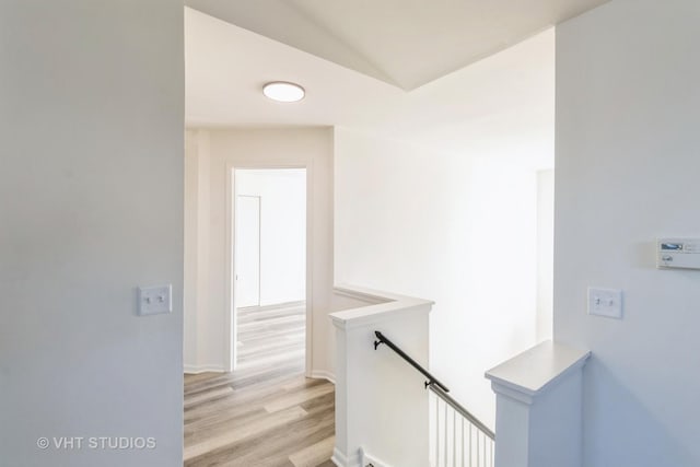 hallway with light hardwood / wood-style floors