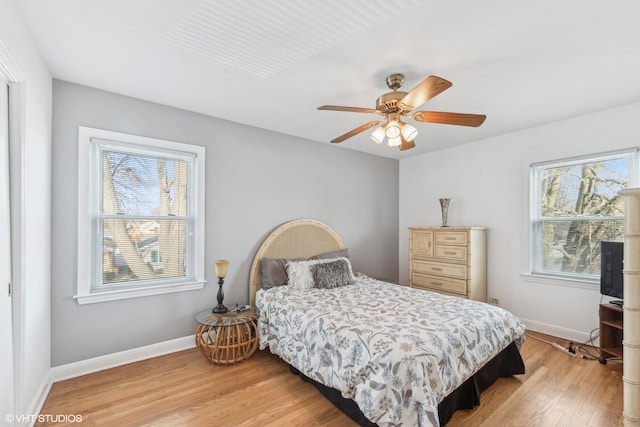 bedroom with light hardwood / wood-style flooring and ceiling fan