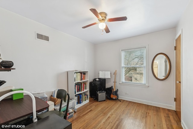 office space featuring light hardwood / wood-style floors and ceiling fan