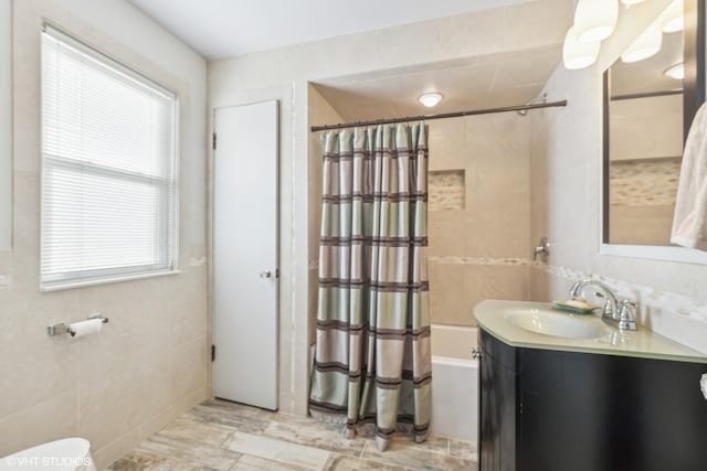 full bathroom featuring vanity, toilet, shower / bathtub combination with curtain, and a wealth of natural light