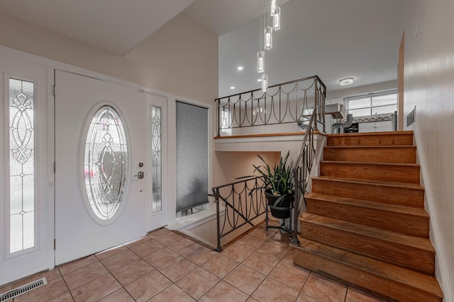 entrance foyer with light tile patterned floors and a healthy amount of sunlight