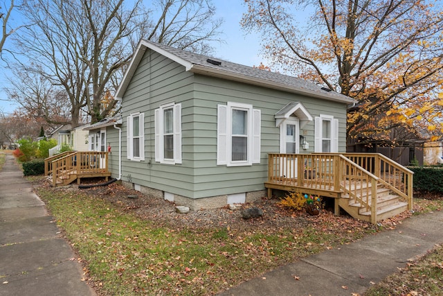 bungalow-style home featuring a wooden deck