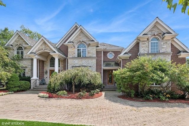 view of front of house featuring brick siding and stone siding