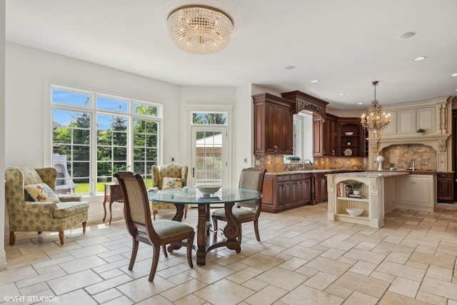 dining area featuring an inviting chandelier, recessed lighting, and stone finish flooring