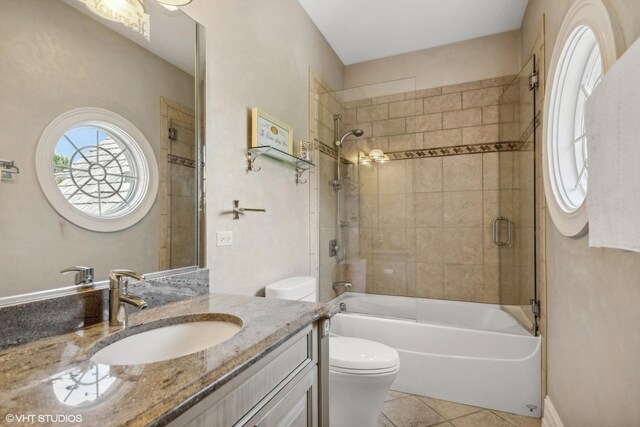 full bathroom featuring vanity, tile patterned floors, toilet, and bathtub / shower combination