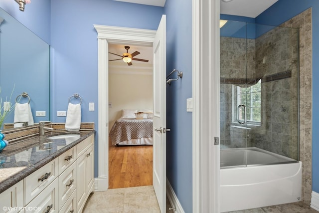 bathroom with tile patterned flooring, double vanity, combined bath / shower with glass door, ensuite bath, and a sink