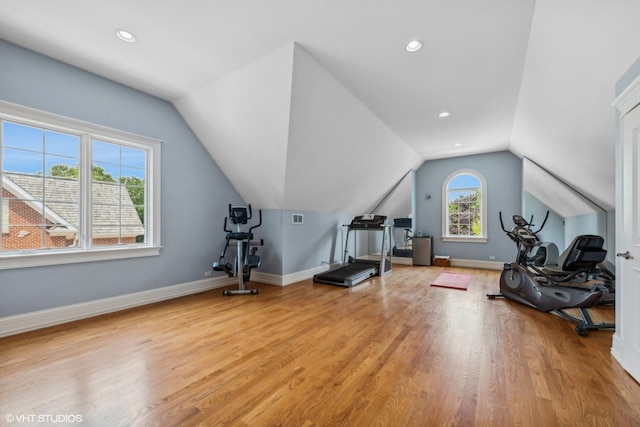 exercise area featuring recessed lighting, light wood-style flooring, lofted ceiling, and baseboards