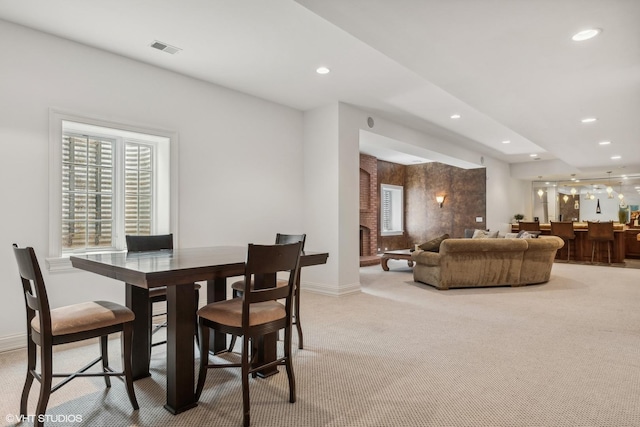 dining room featuring light colored carpet, recessed lighting, visible vents, and baseboards