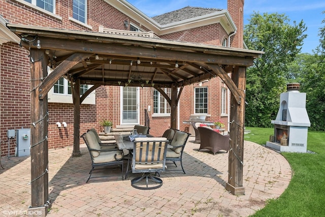 view of patio / terrace featuring a gazebo, a grill, and outdoor dining space