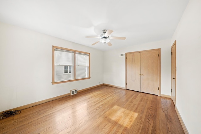 unfurnished bedroom with ceiling fan, a closet, and light hardwood / wood-style flooring