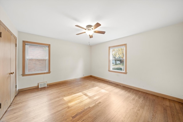 spare room featuring light wood-type flooring and ceiling fan