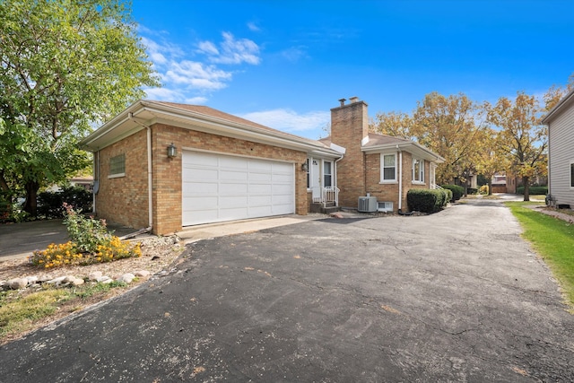 view of front facade featuring a garage and central AC