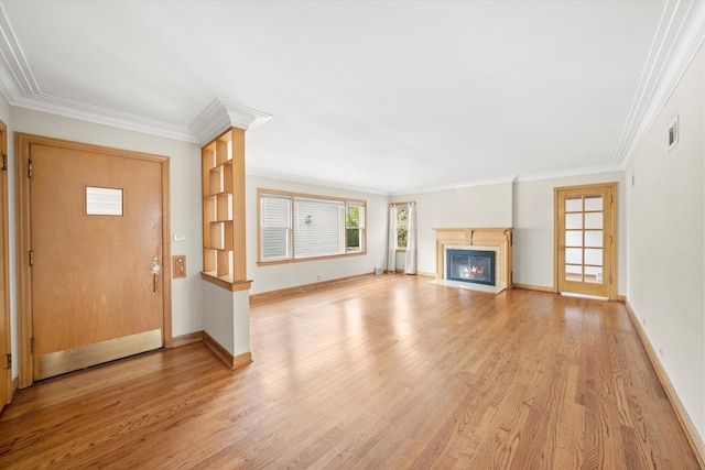 unfurnished living room with light hardwood / wood-style floors and ornamental molding