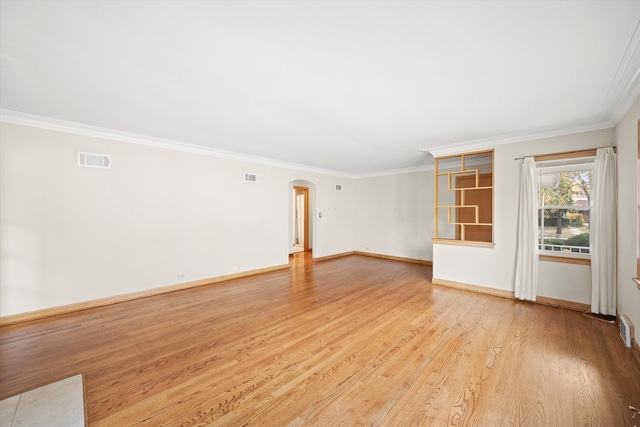 unfurnished room featuring crown molding and light hardwood / wood-style floors