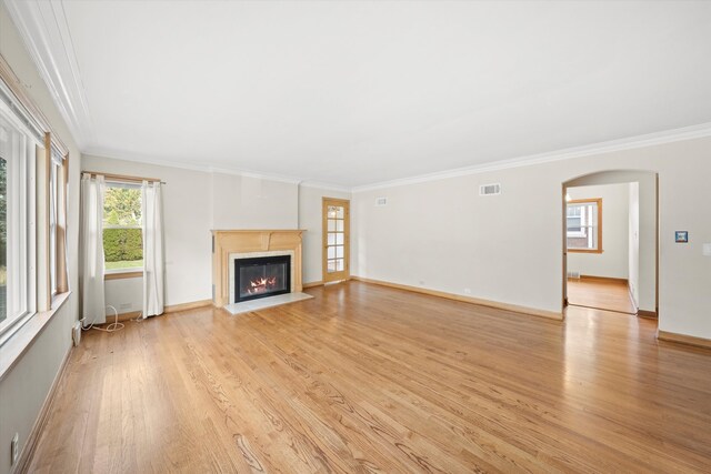 unfurnished living room with light hardwood / wood-style flooring and ornamental molding