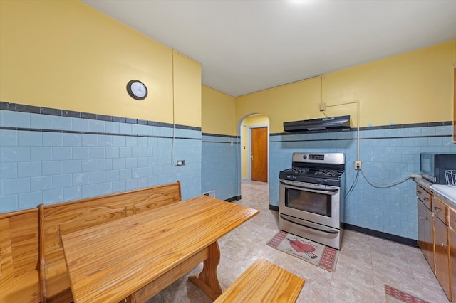 kitchen with tile walls and appliances with stainless steel finishes