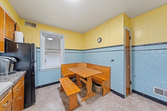 dining area with tile walls