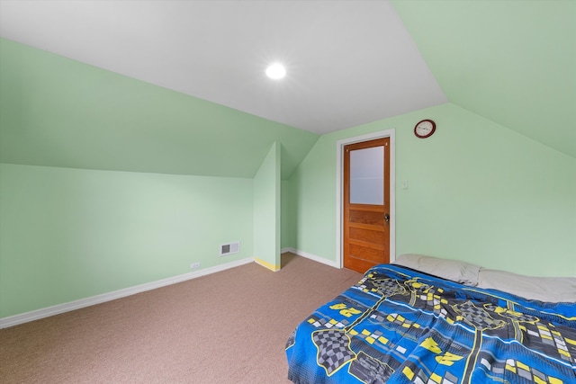 unfurnished bedroom featuring carpet and lofted ceiling