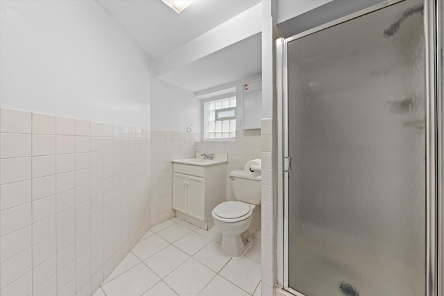 bathroom with vanity, tile patterned floors, toilet, tile walls, and an enclosed shower