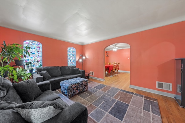 living room featuring ceiling fan and hardwood / wood-style floors